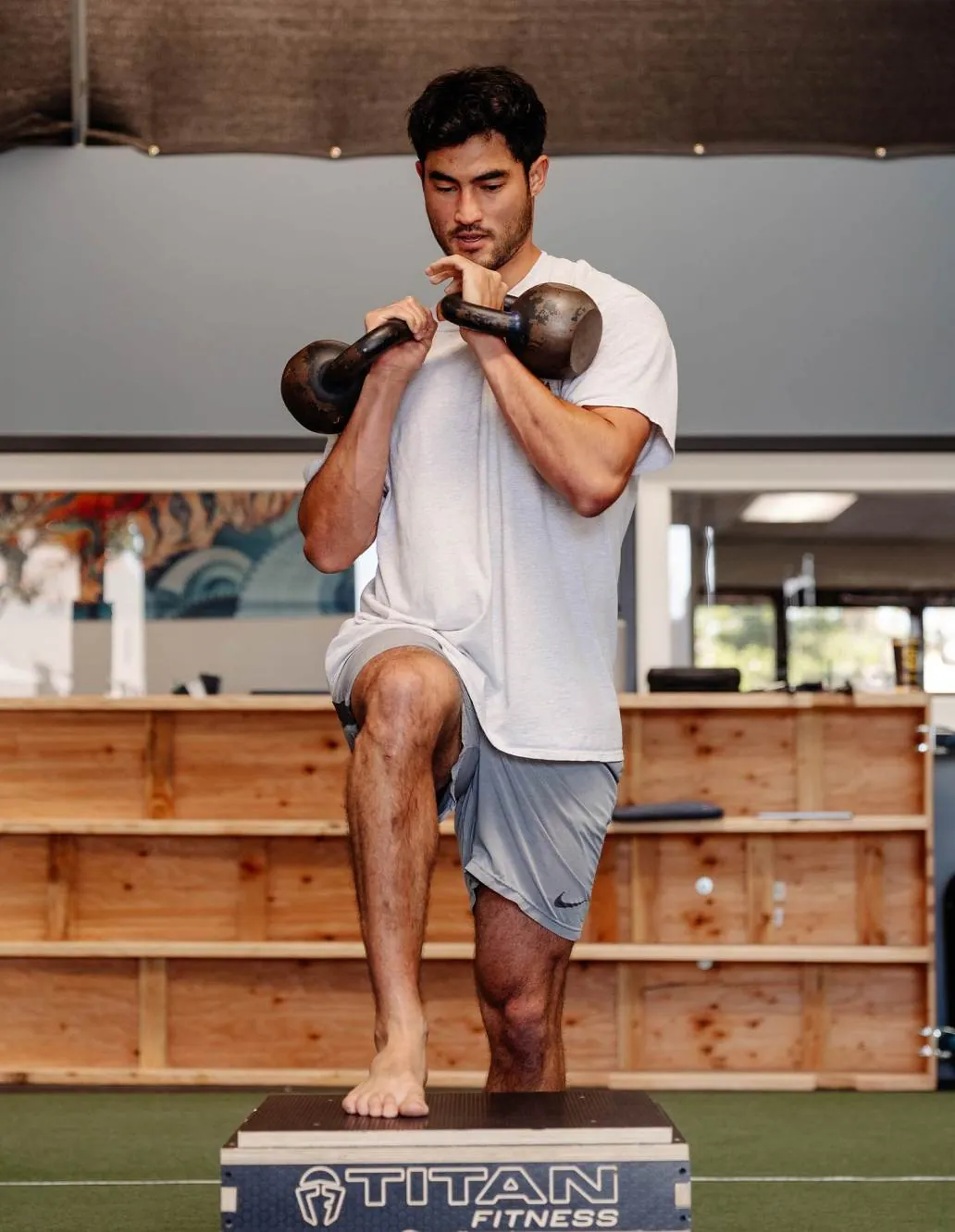 An athlete under load in a kettlebell box march